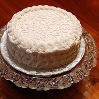 White Cake This is a white cake with strawberry filling and buttercream frosting. The top is cornelli lace and the border and sides are supposed to be...