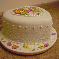 Engagement Cake Cake for an engagement party using the new stencil design on the side, with fondant pearls and royal icing piped flowers on the top.