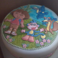 Dora The Explorer Birthday cake for a six year old girl who requested a Dora the Explorer theme. Figures made in royal icing floodwork, cake covered in...