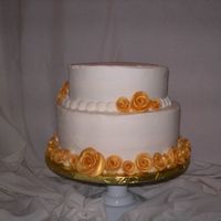 50Th Wedding Anniversary Chocolate 10 in cake and yellow 8 in cake with buttercream icing and fondant roses painted with gold dust.