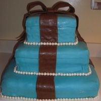 Tiffany Blue And Brown ok this is the first large cake i have made with fondant. It was hard to cover the larger pieces witht the fondant. The over all apperance...
