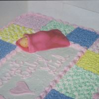 Fondant Baby On Quilt Cake This is a close-up (kinda) of a sleeping baby made of fondant I put on top of a baby quilt cake I did for a baby shower. This was my first...