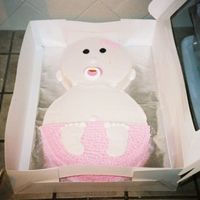 Baby Cake This is icied w/ whipped icing. My first baby shower cake. I used a real pacifier in the babies mouth. I'm very new to cake decorating...