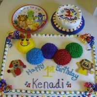 Baby Einstein This was a baby einstein b-day cake made using cupcakes for the catapiller and FBCT for the dog and lion. Smash cake too!