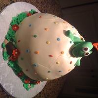 Baby Dinosaur Hatching Egg cake made with Wonder mold and a 9" round covered in fondant. The dinosaur is fondant and was inspired by some 3D figures here on...