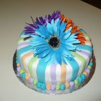 Bright Colored Bridal Shower Double 10" Chocolate cake covered in white fondant with purple, aqua, orange and green stripes and artificial flowers.