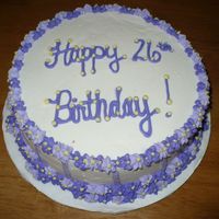 Purple & White Birthday Cake Two 9" chocolate rounds, topped with White Buttercream icing and Purple and Lavender buttercream flowers. This was my first attempt at...