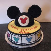 Mickey Mouse Cake 10" white/chocolate filled and iced with bc. Mickey hat is chocolate cake iced with choc bc. The colored mickey's on the sides...