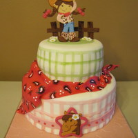 Yee-Haw! One vanilla one chocolate layer, iced in buttercream covered in MMF with MMF accents and "painted" lines. Second picture is the...