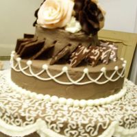 80Th Birthday Cake Bottom layer has Cornelli Lace, Middle layer has squares of chocolate with a transfer pattern on them, and Top layer has roses hand-molded...