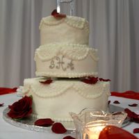 White Wedding Cake With Cornelli Lace This is a 3-tiered white cake with white buttercream, Cornelli lace on the op and down the sides with pearl borders all around and a silver...