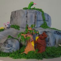 Animals At The Cliff This cake is made to resemble a section of cliff. It has a snake curled up in the sun on top. A mouse enjoying some cheese to the left. The...