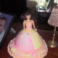 Emily's Doll Cake This cake was made for my daughter's 6th birthday. Chocolate cake with buttercream icing, covered in MMF that was marbled pink, yellow...
