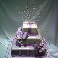 Lilac Parcel Cake a stacked parcel cake with a handmade crystal and lilac topper