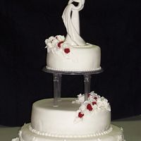 3 Tier With Red Roses. This 3 tiered cake was made for a friends daughters wedding. Her colors were red, black and white. The cake is white with raspberry filling...