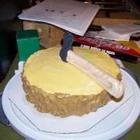 Kyle's B-Day Cake The "log" is iced with butter cream and the tomahawk is gum paste.