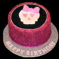 Girly Skull Vanilla cake, chocolate buttercream, covered in sugar sparkles with a fondant plaque