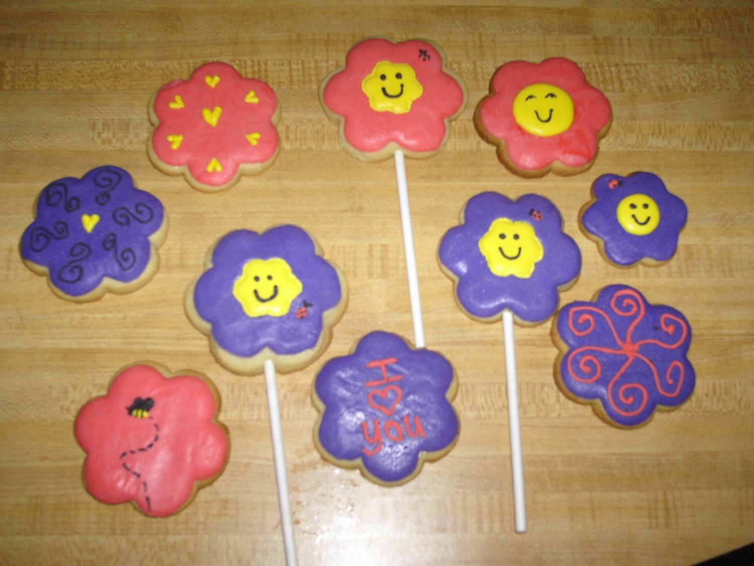 Pic144.jpg 1st attempt at decorating cookies. Used rolled buttercream, then decorated with royal icing. Made them for my mother-in-law after her...