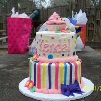 Raindbow Stripes & Dots this is a 6" & 8" cake with a standard size cupcake on top. The board is a 12" round. It's all buttercream with...