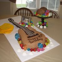 Guitar I made this for my grandfather who loves to play the guitar. The fret board is made from solid chocolate. The cake was carved from (2) 11 x...