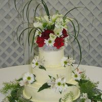 Simple Wedding Cake This is a cake I made. It was very simple, All buttercream Bead border on top & bottom. The flowers were fresh. The florist didn't...