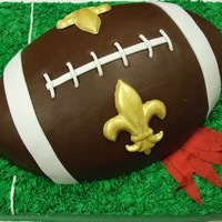 Crushed Cardinals Chocolate sheetcake with 3D football cake covered in fondant on top. The feathers represent the Arizona Cardinals :)