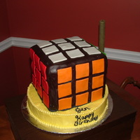 Rubik's Cube Rubik's cube cake 6*6 on a 10 inch round. Cube all fondant. Got ideas from other decorates on here. (thank you).