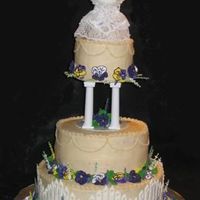 Pansies This is supposed to be an ivory cake, but it looks yellow next to the white accents. The flowers are royal icing and the fence is color...