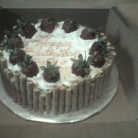 Cake With Rolled Wafers Vanilla rolled wafers around 2 layer yellow cake with buttercream frosting and garnished with fresh strawberries.