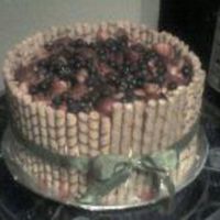Rolled Wafers With Fruit Topping This is a 2 layer white and strawberry cake with buttercream icing topped with strawberries and blueberries, then I surrounded the cake...