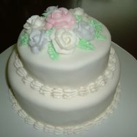 First Stacked Cake Covered in fondant with BC roses. Just wanted to practice making a stacked cake and needed the practice covering with fondant too.