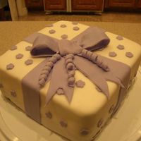 Present Cake Just a simple present cake I did a couple of weeks ago. It is Wilton fondant :P, chocolate fudge cake, and peanut butter filling.