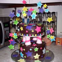 Shooting Stars This was a vanilla cake iced in chocolate ganache. The stars are made of fondant and covered with colored sugar. Before the fondant dried...