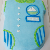 Baby Shower Onesie Single layer white 11"x15" carved onesie covered in vanilla buttercream. Fondant sail boat and plaque.