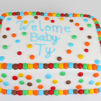 Welcome Baby Ty 9"x13" double layer strawberry cake with sliced strawberries in between labels. Covered in buttercream with buttercream polka...