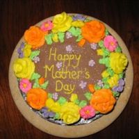 Img_5492.jpg Chocolate cake with chocolate buttercream. Buttercream roses, rosebuds and leaves, royal icing pink and purple drop flowers and pansies.