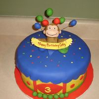 Curious George BC with fondant accents and George is Gumpaste. I forgot to take the balls of fondant under his arms off before I took the picture. I had...