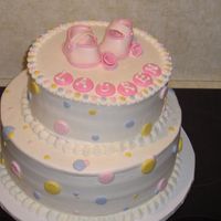 Baby Shower Cake 11" round on bottom 8" round on top. All buttercream except shoes, ribbon roses and name