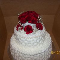 Lizz_Pics_002.jpg This was my first time to try this, I think I need more practice, it's a white cake with buttercream and with real mini red carnations...