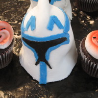 Star Wars Captain Rex Extra large cupcake pan used. French Vanilla cake with homemade fondant (1st time ever making it - harder than I thought.). Side cupcakes...