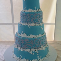 5 Tier Ocean Blue The silver area was done with the Cricut all the flowers are gumpaste. Once my business partner got the right mix of gumpaste, Satin Ice,...