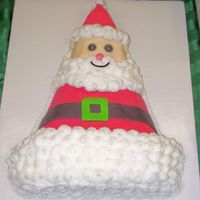 Santa Triangle This cake was made from the Wilton party hat pan. A few trims and it's transformed into a Santa, covered in fondant with buttercream...