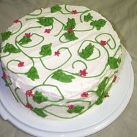 Raspberry Delight Meringue buttercream with crisco buttercream vines and flowers. Raspberry jam between torted layers.