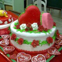 Two Hearts In One Butter cake finished with fondant, flowers are made of gumpaste just done the night before, others leaves are madee of royal icing.