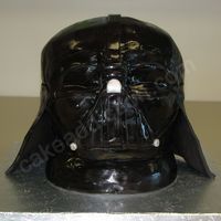 Darth Vader This is a sculpted Star Wars themed, Darth Vader cake. It was white cake with a buttercream filling. I sculpted it after I stacked the cake...