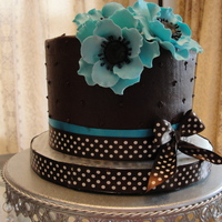 Ganache Frosting With Gumpaste Flowers. Chocolate cake with Ganache filling and frostine.Handmade gumpaste flowers.