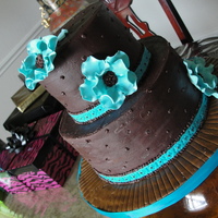 Ganahce Wedding Cake 5" and 8" rounds.Gumpaste flowers.Chocolate cake with Peanut Butter Chocolate filing and iced with Chocolate Ganache' .