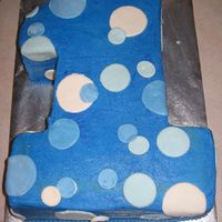 Parker's First Birthday Cake Two half-sheet cakes stacked, covered in crusting buttercream with MMF circles. Thanks for looking; I was so excited for my little boy'...