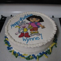 Dora And Boots Colorflow technique for picture with buttercream icing, fondant curlies around base.