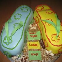 Flips Flops Choc. w/ strawberries and banana whipped cream filling and a pineapple cake with coconut icing and filling. Both covered in fondant. Shells...